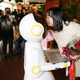 A woman in China kisses a restaurant robot server that has brought her roses